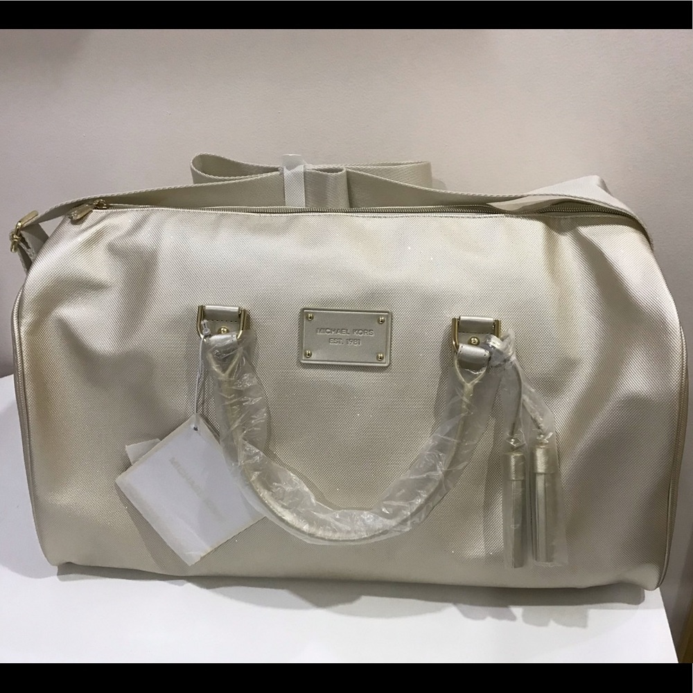 Brand new Michael Kors gold weekender travel bag